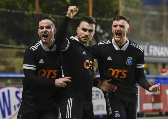 Ian McShane (centre) celebrates for Darvel