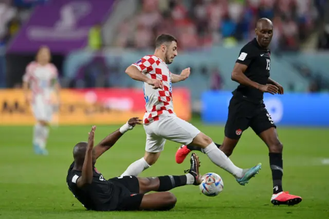 Josip Juranovic of Croatia is tackled by Kamal Miller of Canada during the FIFA World Cup Qatar 2022 Group F match between Croatia and Canada at Khalifa International Stadium on November 27, 2022 in Doha