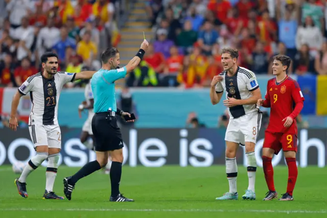 Leon Goretzka is shown a yellow card