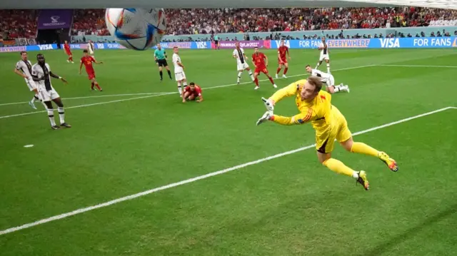 Manuel Neuer tips Dani Olmo's shot onto the bar