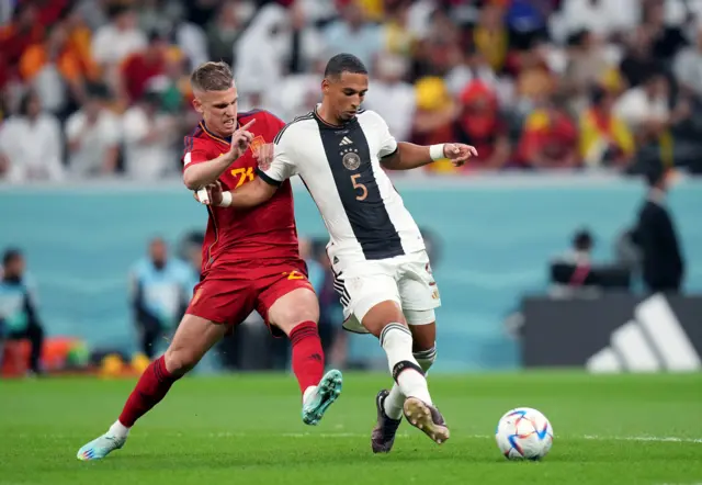 Spain's Dani Olmo (left) and Germany's Thilo Kehrer battle for the ball during the FIFA World Cup Group E match at the Al Bayt Stadium, Doha, Qatar