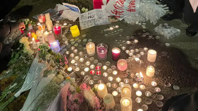 People left flowers and lit candles outside the Chinese embassy in London