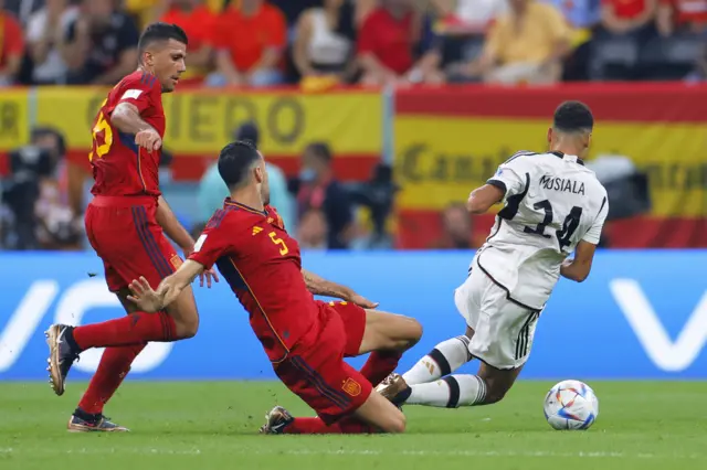 Jamal Musiala is fouled by Sergio Busquets