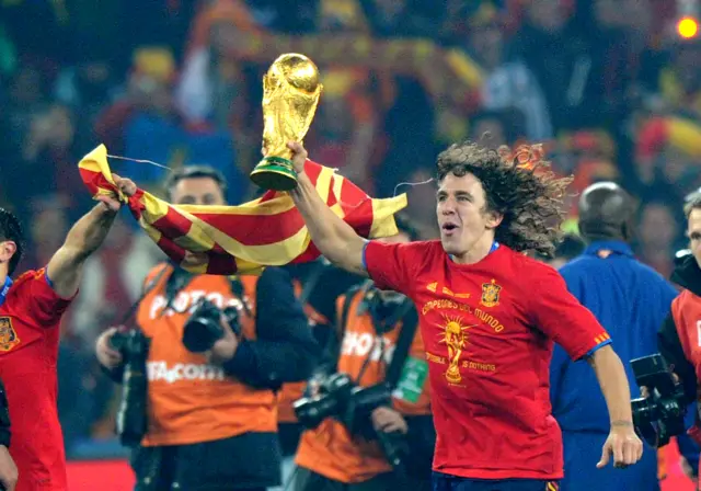 Carlos Puyol with the World Cup trophy