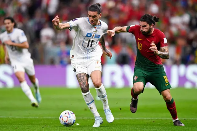 Darwin Nunez of Uruguay battles for the ball with Ruben Neves of Portugal during the Group H - FIFA World Cup Qatar 2022 match between Portugal and Uruguay at the Lusail Stadium on November 28, 2022 in Lusail City, Qatar