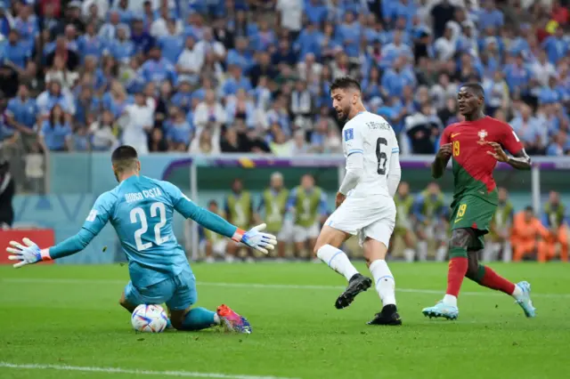 Rodrigo Bentancur of Uruguay shoots the ball against Diogo Costa of Portugal during the FIFA World Cup Qatar 2022 Group H match between Portugal and Uruguay at Lusail Stadium on November 28, 2022 in Lusail City, Qatar.