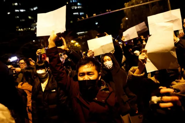 In Beijing, protesters held up blank sheets of paper to signal their discontent