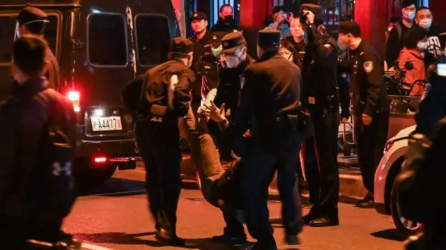 - A man is arrested while people gathering on a street in Shanghai on 27 November