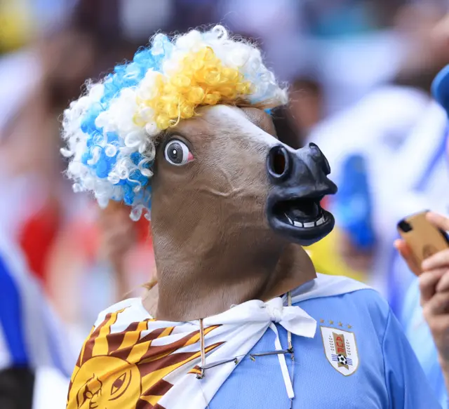 A Uruguay fan wears a horse mask during the FIFA World Cup Qatar 2022 Group H match between Uruguay and Korea Republic at Education City Stadium on November 24, 2022 in Al Rayyan