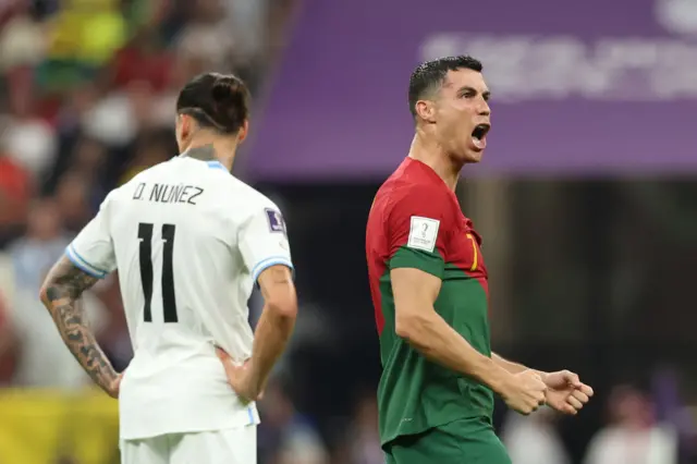 Darwin Nunez of Uruguay reacts as Cristiano Ronaldo of Portugal celebrates after scoring to give the side a 1-0 lead during the FIFA World Cup Qatar 2022 Group H match between Portugal and Uruguay at Lusail Stadium on November 28, 2022 in Lusail City