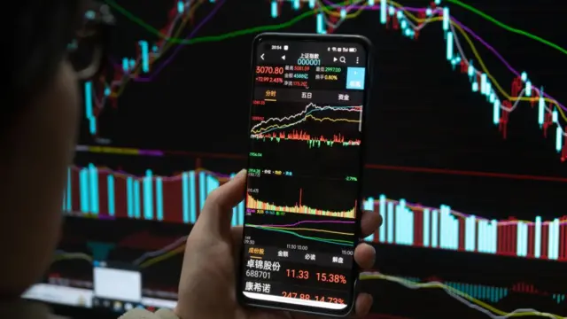 A shareholder checks the closing stock index of the A-stock market in Shanghai, China