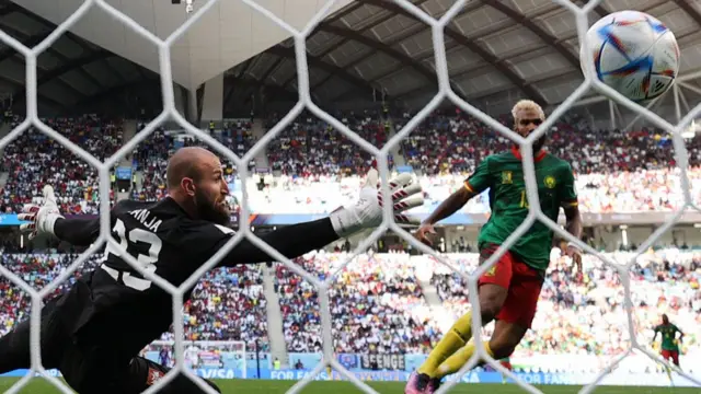 Cameroon's forward #13 Eric Maxim Choupo-Moting (R) scores his team's third goal