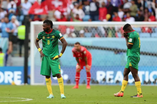 Cameroon players look sad after defeat to Switzerland