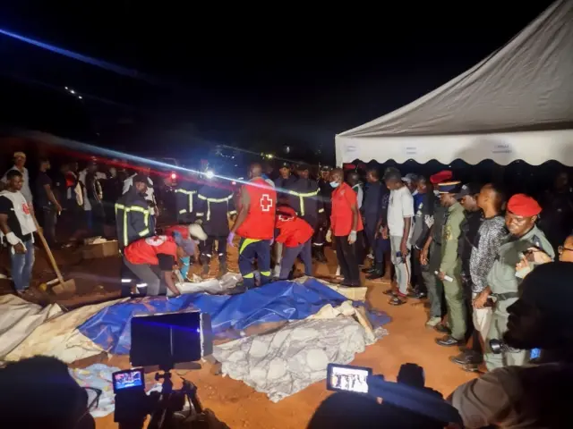 Rescuers prepare to carry a body after a landslide, which killed people who were attending a funeral, the governor of Cameroon"s Centre Region said, in Yaounde, Cameroon November 27, 2022