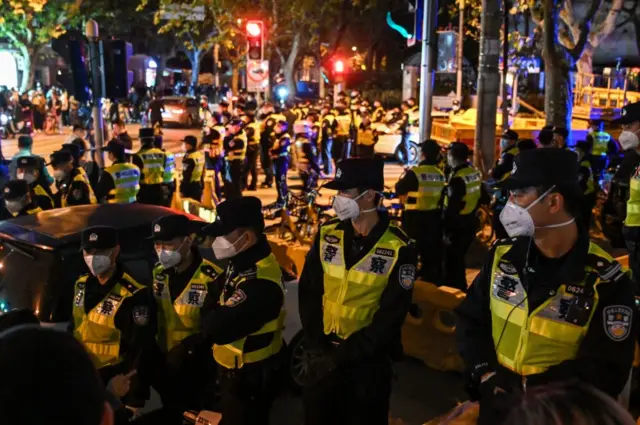 While in Shanghai on Sunday, police officers blocked Urumqi road