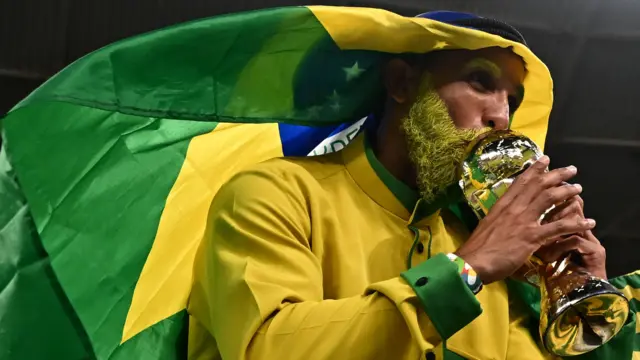 A Brazil supporter wearing a flag