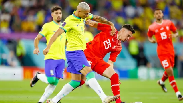 Richarlison of Brazil and Fabian Rieder of Switzerland battle for the ball