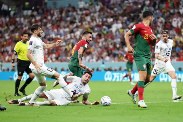 Bruno Fernandes of Portugal controls the ball against Jose Maria Gimenez of Uruguay during the FIFA World Cup Qatar 2022 Group H match between Portugal and Uruguay at Lusail Stadium on November 28, 2022 in Lusail City, Qatar. Gimenez was called for a handball resulting in a penalty kick after a Video Assistant Referee review