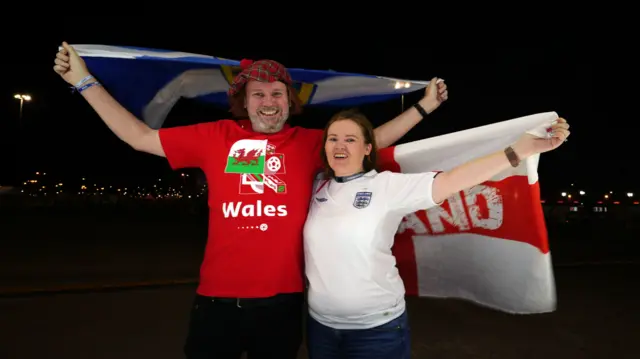 A Wales and England fan who live in Qatar are pictured ahead of the FIFA World Cup Group B match at the Ahmad Bin Ali Stadium