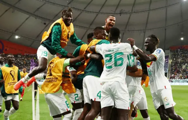 Senegal's Ismaila Sarr celebrates scoring their first goal with teammates