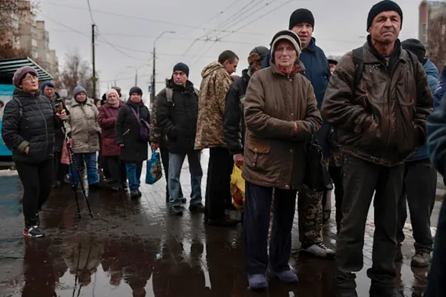 People queue to receive food in Chernihiv