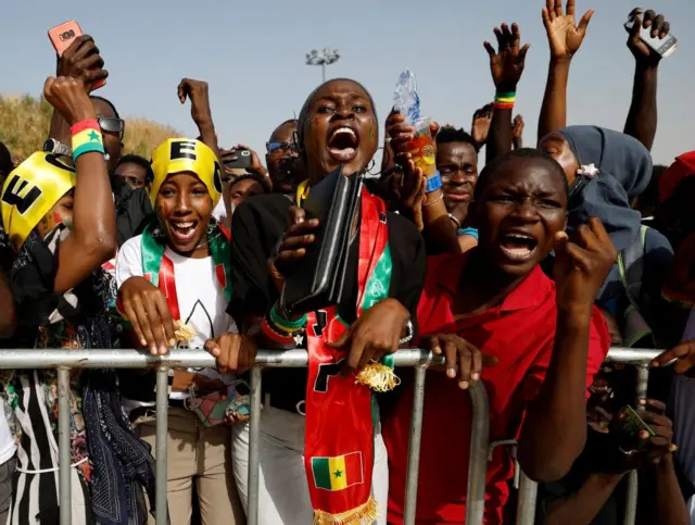 Soccer Football - FIFA World Cup Qatar 2022 - Fans in Dakar watch Ecuador v Senegal - Dakar, Senegal - November 29, 2022 Senegal fans celebrate during the match