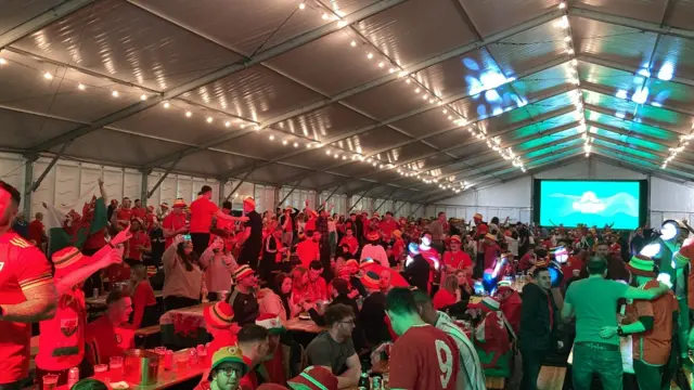 Football fans at a fanzone in Swansea