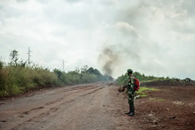 A Congolese waits for the next army convoy heading towards the front line near Kibumba in the area surrounding the North-Kivu city of Goma in May.