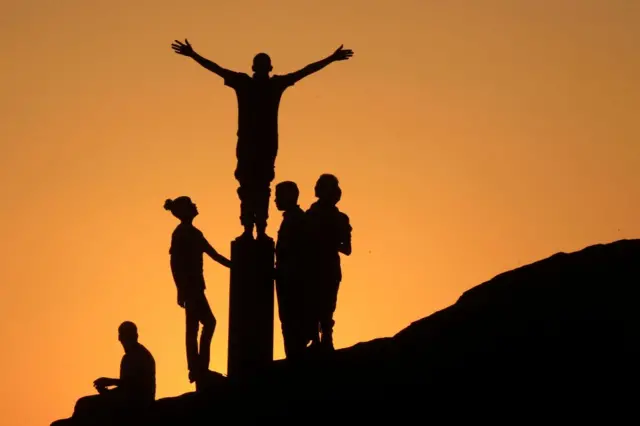 A group of teenagers pose for a photo on a high point overlooking the River Nile and Karima city in Sudan.