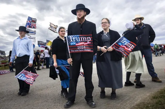 Members of the Old Order Amish community gather for a political rally with former President Donald Trump