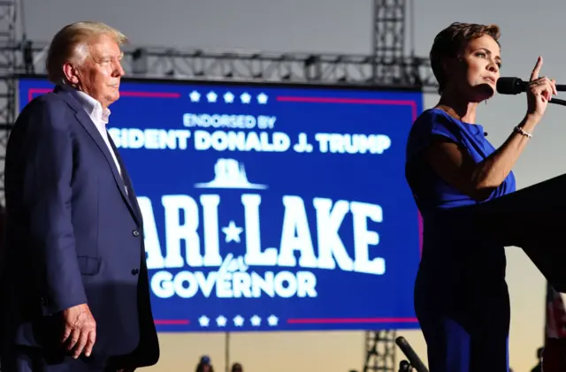 Photo of Donald Trump supporting Kari Lake at a rally in Arizona.