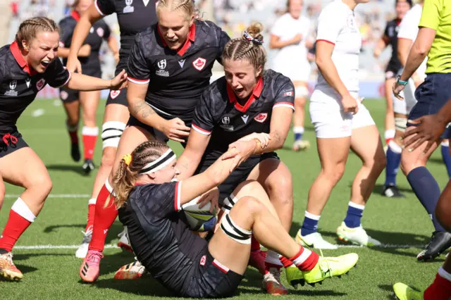 Karen Paquin of Canada scores a try and is congratulated by Maddy Grant