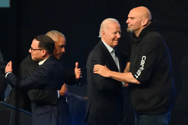 Former US President Barack Obama embraces Democratic Gubernatorial candidate for Pennsylvania Josh Shapiro, as US President Joe Biden embraces Democratic US Senate candidate John Fetterman, during a rally ahead of the midterm elections in Philadelphia, Pennsylvania, on 5 November 2022