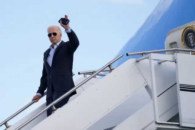 Joe Biden waves as he disembarks from Air Force One