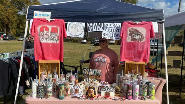 A woman selling Georgia University clothing