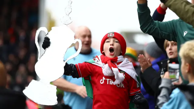 A young Wrexham fan celebrates