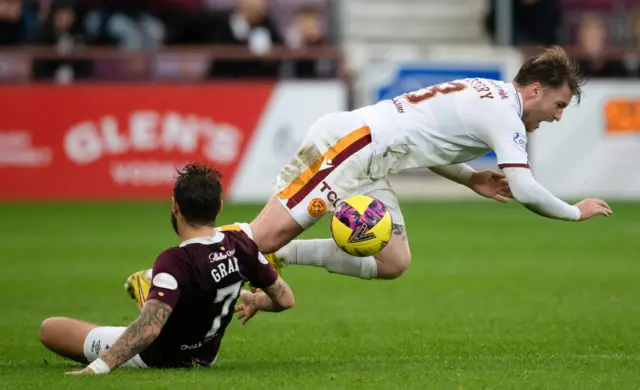 Jorge Grant tackles Callum Slattery before being sent off for serious foul play