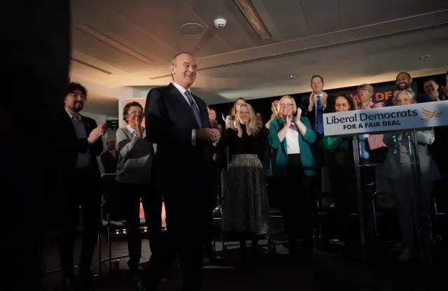 Ed Davey smiles after delivering his speech