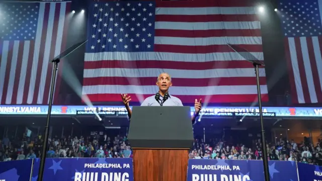 Barack Obama speaks at a podium during a rally