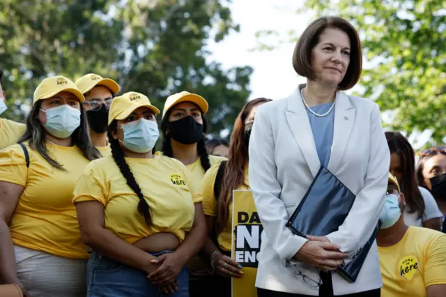 Image shows Democratic Senator Catherine Cortez Masto standing with activists