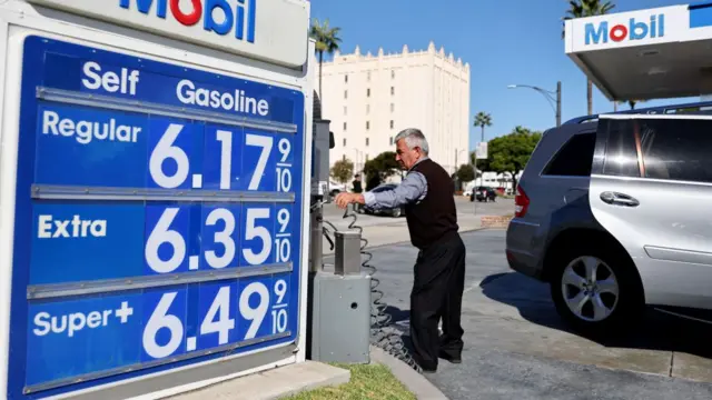 A man pumping gas in California