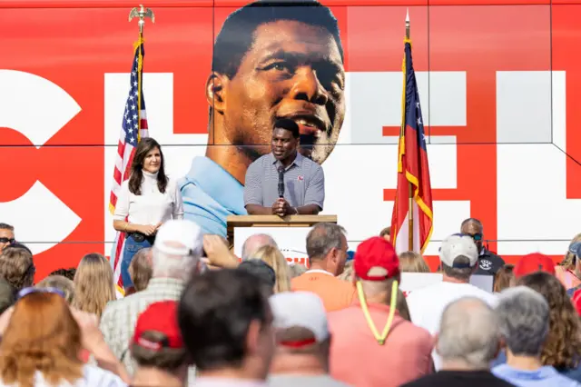 Georgia Senate Republican candidate Herschel Walker speaks at a rally in Hiram, Georgia on Sunday with Nikki Haly, former US ambassador to the United Nations under Donald Trump.