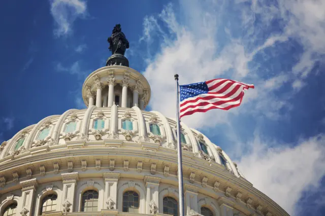 Close up of US Capitol dome with American flag