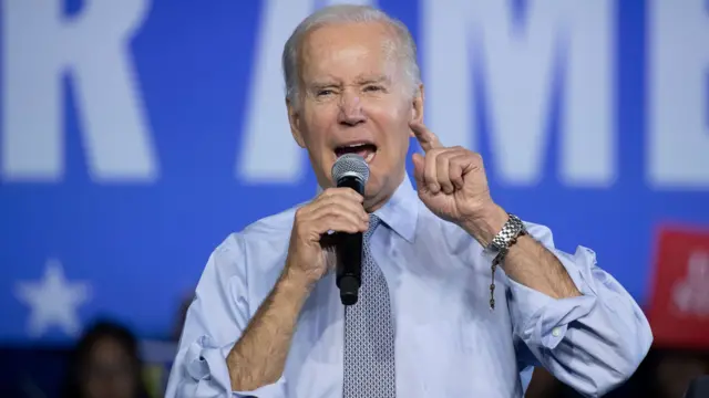 Joe Biden speaks into a microphone during a rally