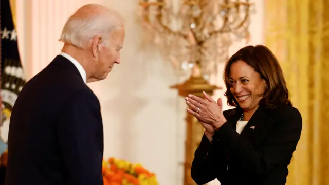 Kamala Harris clasps her hands together and looks delighted at Joe Biden at a Diwali reception in October