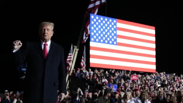 : Former U.S. President Donald Trump greets supporters before a rally at the Dayton International Airport on November 7, 2022 in Vandalia, Ohio.