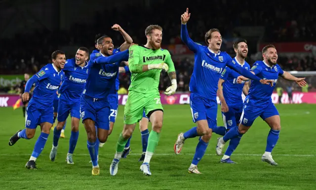 Gillingham players celebrate after beating Brentford on penalties in EFL Cup third round