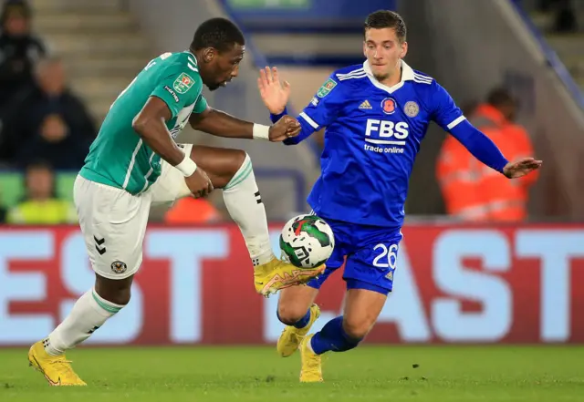 Leicester City's Belgian midfielder Dennis Praet (R) vies with Newport County's English striker Omar Bogle during the English League Cup third round football match between Leicester City and Newport County at the King Power Stadium