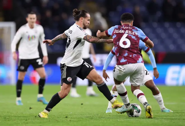 Dom Telford of Crawley Town and CJ Egan-Riley of Burnley battle for possession during the Carabao Cup Third Round match