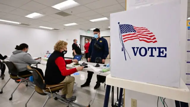 People check in before voting for the 2022 Midterm Elections at the Los Angeles County Registrar in Norwalk, California on November 8, 2022.